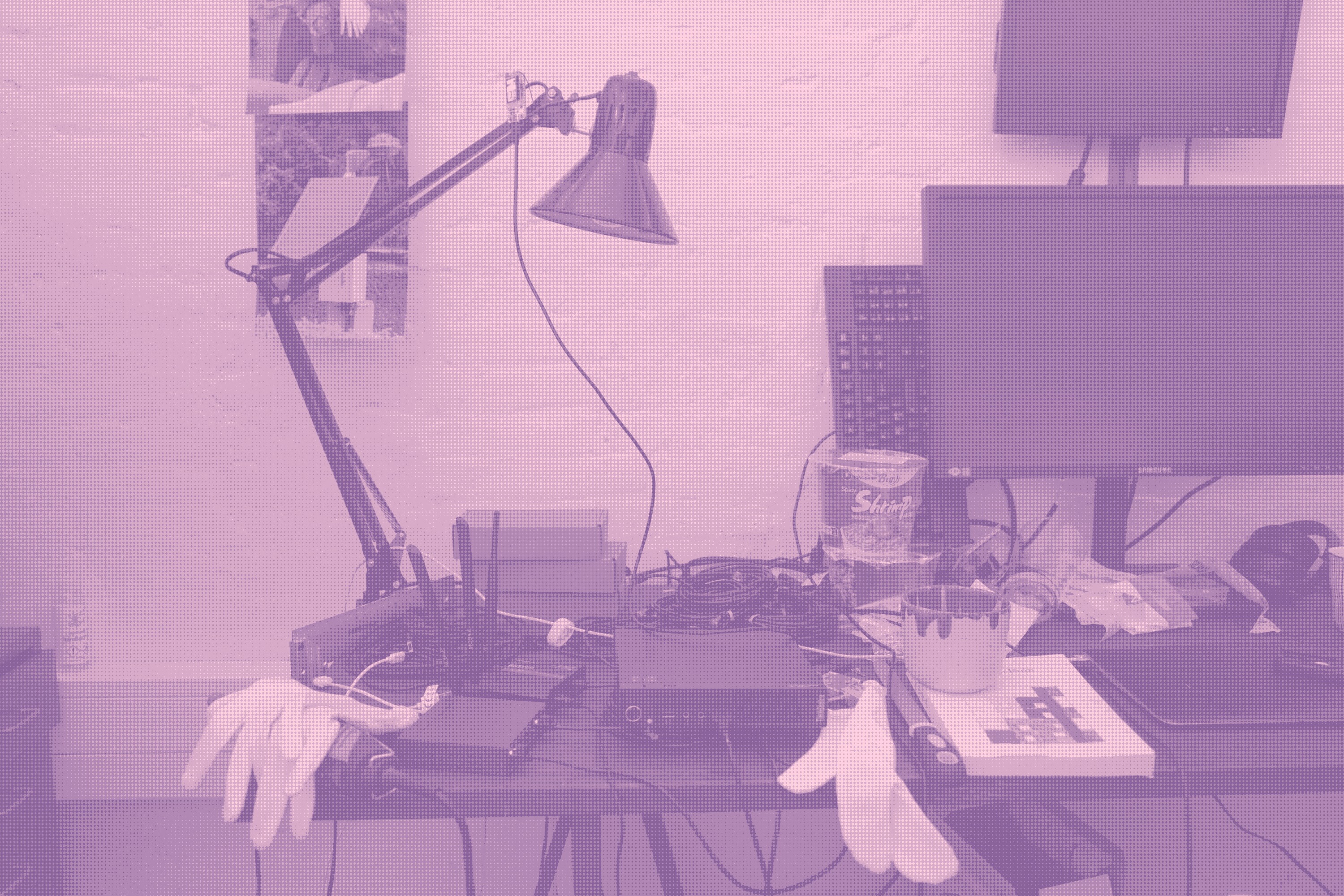 on the picture: studio desk with random stuff such as instant noodles, books and archival gloves. Central is a tinypc, a router, a switch and a LoRa device in the desk lamp. These composes the infrastructure of ethereal plane beside the VPN tunnel that sometimes enables ethereal plane to be exposed to the internet (2026-21-04).